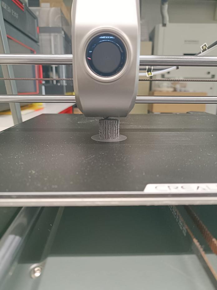 Original photograph of a scaffold prototype being printed beneath the printer nozzle