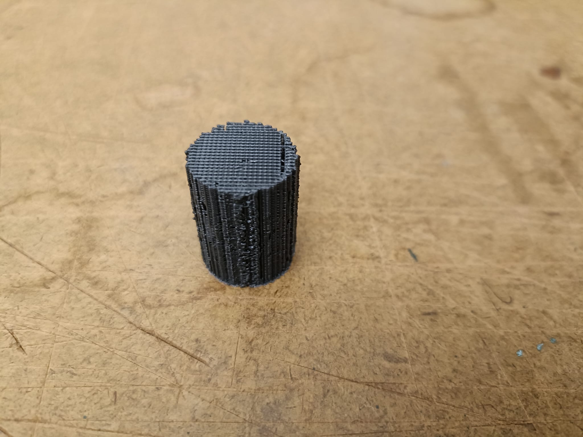 3D-printed scaffold prototype with a visible grid on top and layered side texture